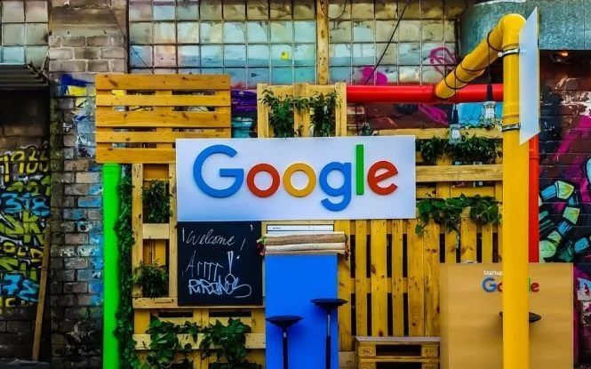 Google sign displayed on a creative pallet wall, symbolizing tools brands use to track digital marketing performance.