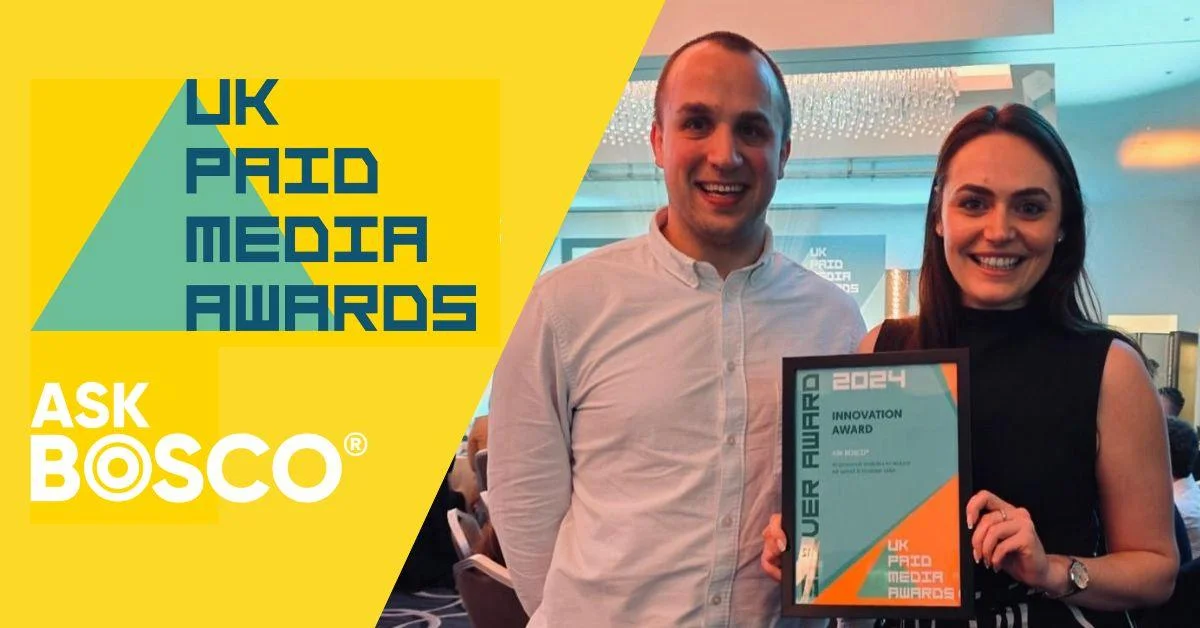 Two people holding ASK BOSCO's Innovation Award at the 2024 UK Paid Media Awards ceremony