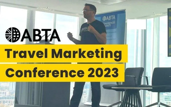 Speaker presenting on stage at the ABTA Travel Marketing Conference 2023, with event banner in background.