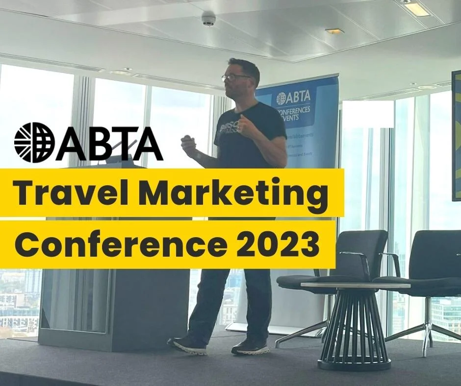 Speaker presenting on stage at the ABTA Travel Marketing Conference 2023, with event banner in background.