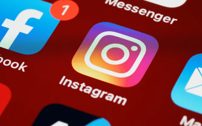 Smartphone screen showing social media app icons, relevant to managing paid social campaigns effectively.