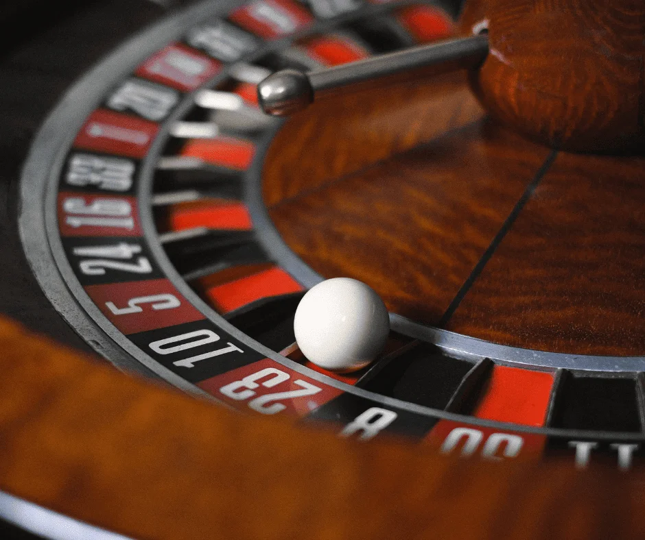 Close-up of a roulette wheel with white ball, symbolizing the gamble of unpredictable ad budget planning.