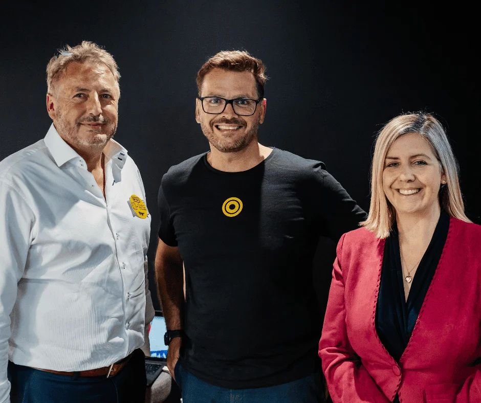Three people smiling together at the official BOSCO™ launch and Modo25 office opening party.