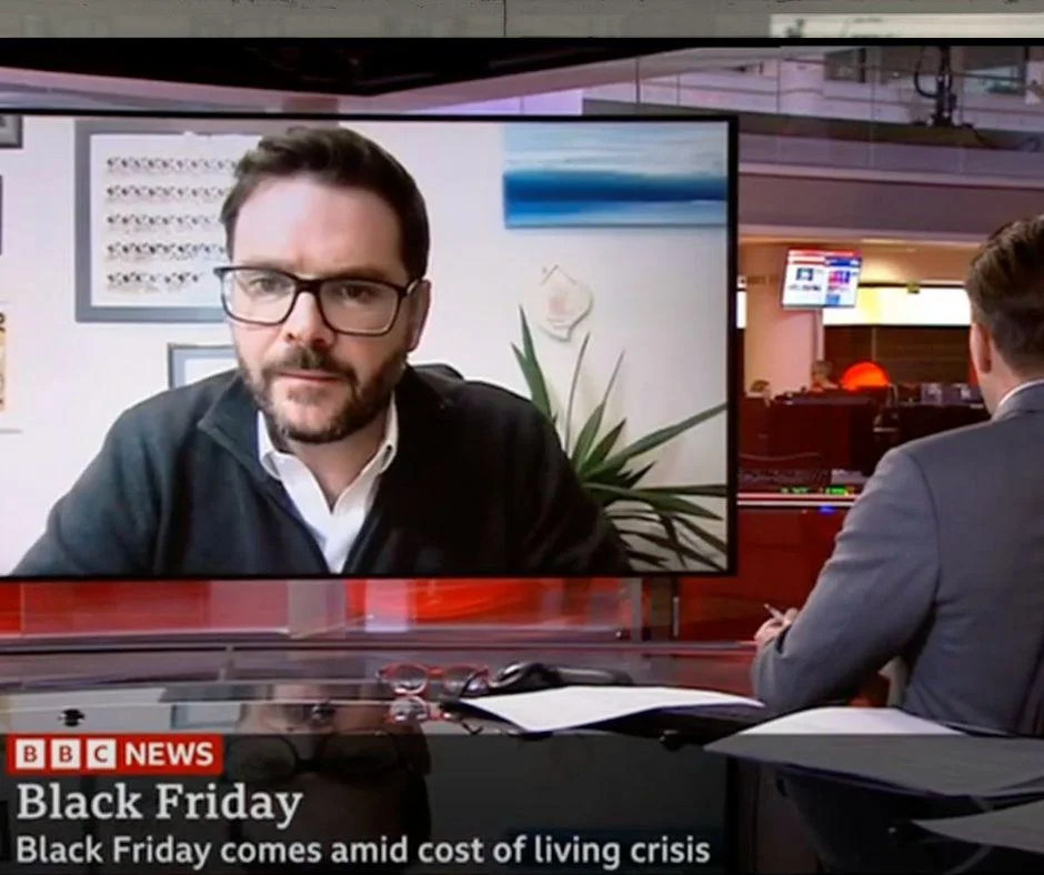 BBC News interview with a bearded expert discussing Black Friday amid the cost of living crisis.