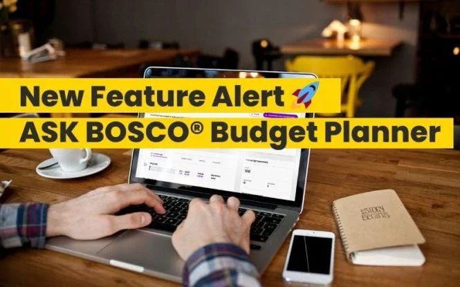 Person typing on a laptop displaying the ASK BOSCO budget planner dashboard on a wooden desk.