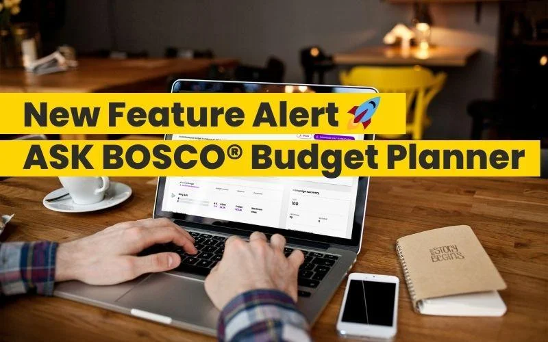 Person typing on a laptop displaying the ASK BOSCO budget planner dashboard on a wooden desk.