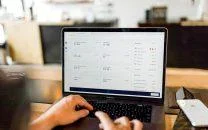 Person viewing a revenue analytics dashboard on a MacBook Pro, reflecting ga4-updates-since-the-move insights