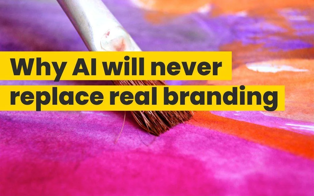 Paintbrush on vibrant watercolor background with headline about why AI will never replace real branding.